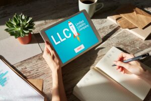 LLC with a rocket on an ipad with a hand holding it